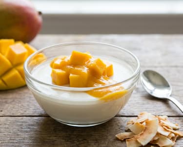 Coconut panna cotta with mango and coconut chips