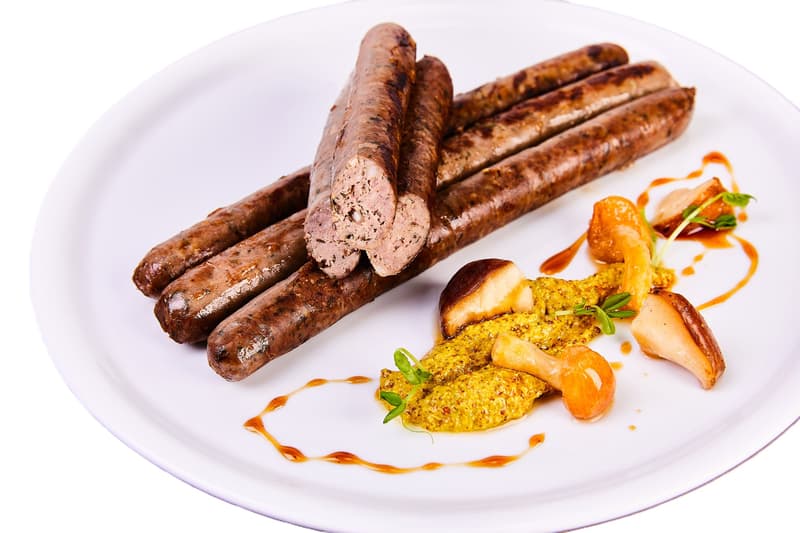 Grilled sausage from duck with boletus and barley pearl sous vide