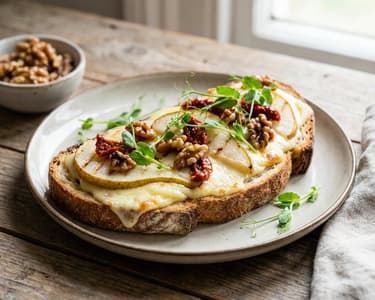 Raclette cheese toast with grilled pear and sun-dried tomatoes